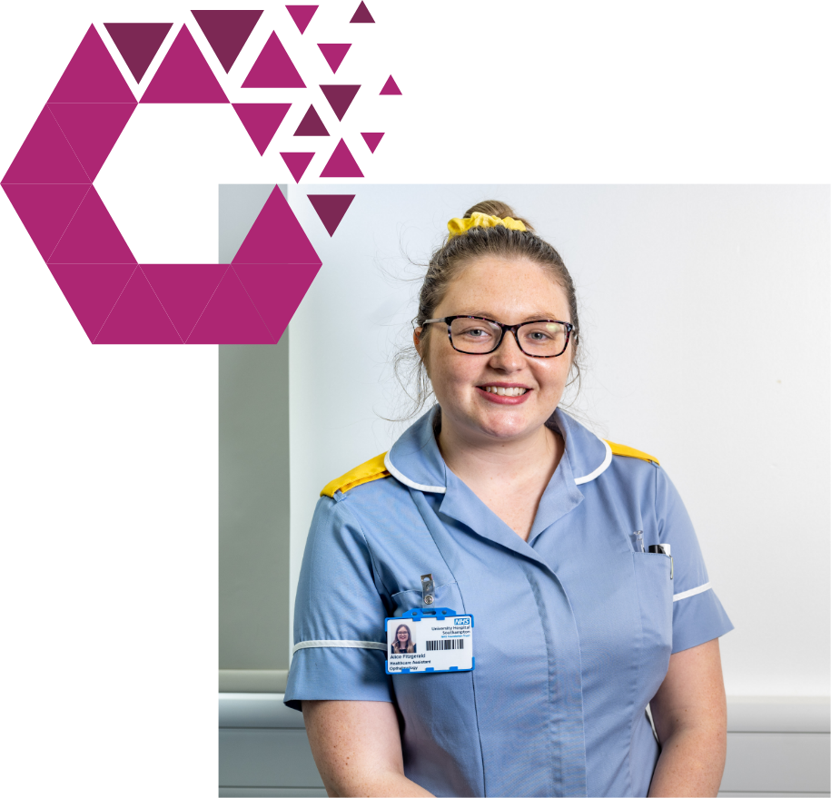 A smiling female nurse in a blue and white uniform, with glasses and her hair tied back, stands in front of a white background. a pink and purple geometric design is on the left side of the image.